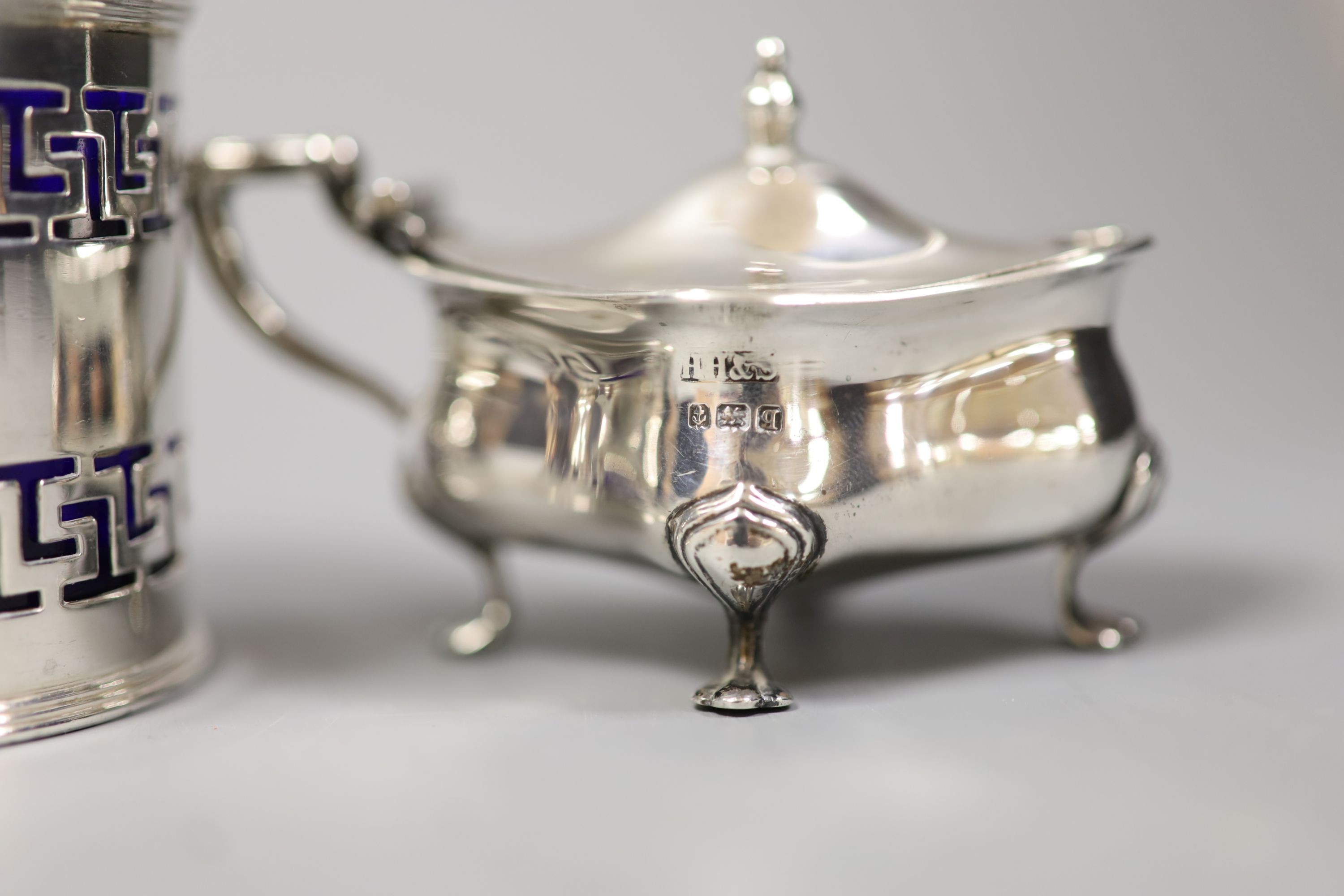 A George III silver two handled boat shaped pedestal salt, London, 179, one other salt and two later silver mustards.